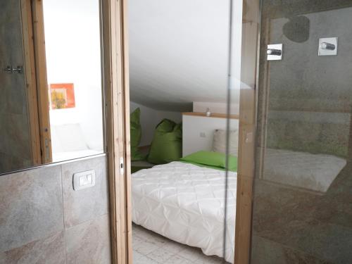 a small bedroom with a bed and a shower at B&B Porto Del Bivio in Duino