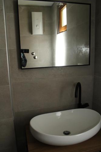 a white sink in a bathroom with a mirror at COUNTRY HOUSE ERDUT in Erdut