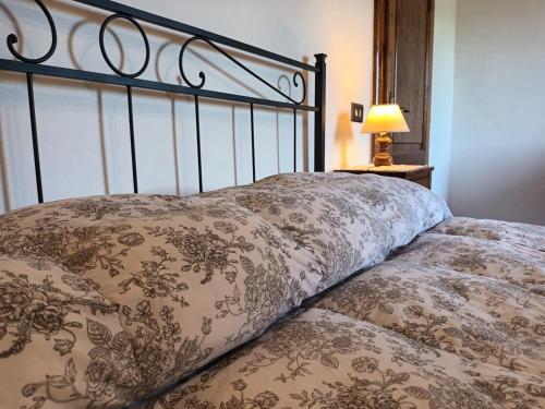a bed with two pillows on top of it at Poggio Massiccioli in Poggibonsi