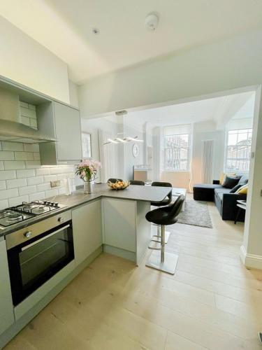 a kitchen with a stove and a counter top at Modern & Spacious 1 Bed Apt, West End in Edinburgh