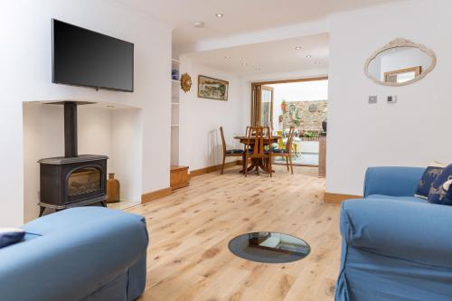 a living room with a couch and a wood stove at 17 Rodney Road - Luxury Apartments in Cheltenham