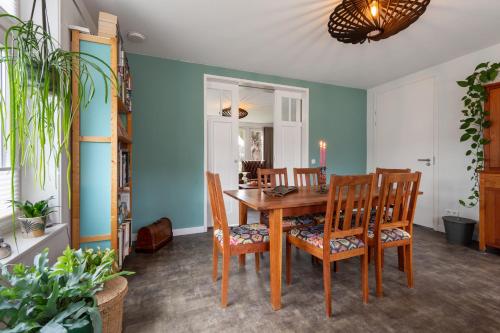 a dining room with a wooden table and chairs at Lowlander BnB in Heemskerk