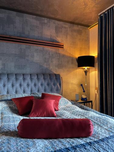 a bedroom with a bed with a red pillow on it at Guest House Bermuuda Family Apartment in Paide