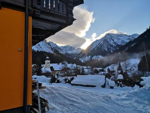 a view of a snow covered mountain range with a building at Almliesl SOEK-660 in Sankt Nikolai im Sölktal