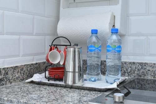 a kitchen counter with two bottles of water on it at Apartamento Juan Dolio Tepuy 701 in Juan Pedro