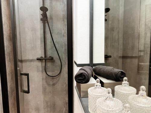 ein Badezimmer mit einer Dusche und zwei gewalzten Handtüchern in der Unterkunft Astrid in Spa