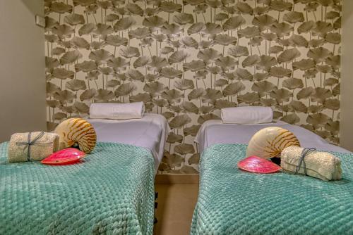 two beds with pillows on them in a room at Eurostars Louxo Talaso in Isla de la Toja