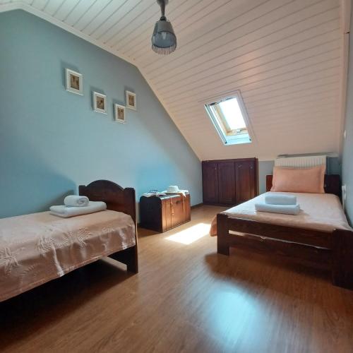 a room with two beds and a couch and a window at Eirinis Home - Σπίτι της Ειρήνης in Áyios Pétros
