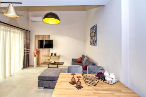 a living room with a couch and a table at Sapphire Horizon Suites in Kissamos