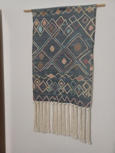 a rug hanging on a wall at Lefteri's Rooms in Agia Galini