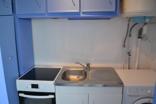une petite cuisine avec un évier et une cuisinière dans l'établissement Résidence Palma proche plage et commerces, à Port-la-Nouvelle
