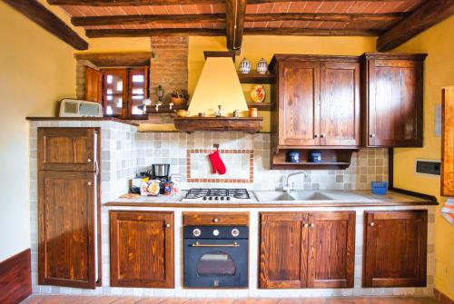 a kitchen with wooden cabinets and a stove top oven at Verzure in Montingegnoli