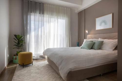 a bedroom with a large bed and a large window at Thisean Modern Suites By Athens Stay in Athens