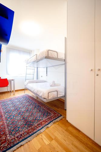 a bedroom with a bunk bed and a rug at Puerto de Luarca By Silastur in Luarca