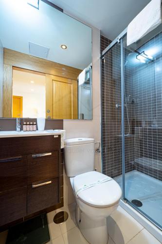 a bathroom with a toilet and a sink and a shower at Puerto de Luarca By Silastur in Luarca