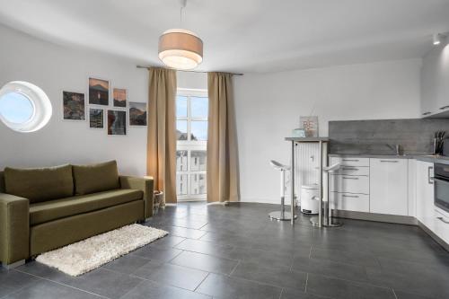 a living room with a couch and a kitchen at Stadtkernnahes Wohnen in Düren in Düren - Eifel