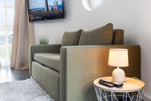 a living room with a couch and a table with a lamp at Stadtkernnahes Wohnen in Düren in Düren - Eifel
