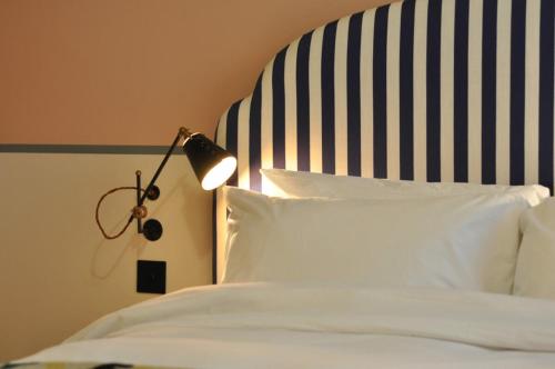 a bed that has a lamp on top of it at room2 Chiswick Hometel in London