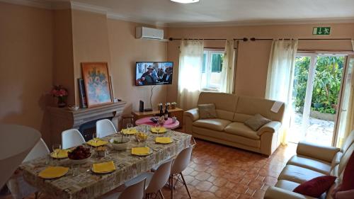 a living room with a table and a couch at Apartamento Solvita in Coimbra