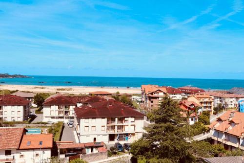 a view of a town with a beach and houses at Apartaments La Reserva Premium in Noja