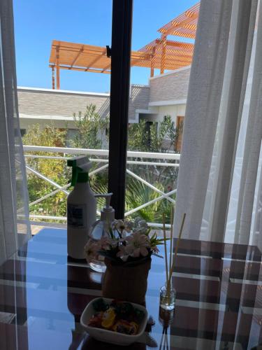 a table with a plate of food and a bottle at Hotel Pacífic Suites Tocopilla in Tocopilla