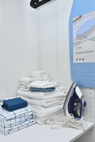 a stack of towels on a shelf with a hair dryer at Apto Juan Dolio Tepuy 601 F in Juan Pedro
