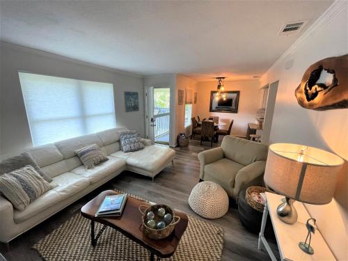 a living room with a couch and a table at St Augustine Beach Condo 3/5 Min Walk Beach/Cafes in St. Augustine