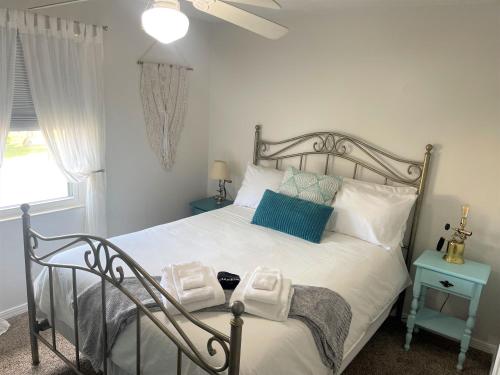 a bedroom with a bed with towels on it at St Augustine Beach Condo 3/5 Min Walk Beach/Cafes in St. Augustine