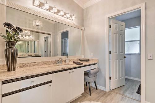 a bathroom with a sink and a large mirror at Inviting Lady Lake House In the Village! in Lady Lake