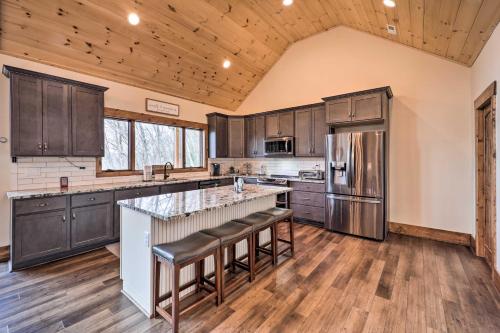a kitchen with wooden cabinets and stainless steel appliances at Mountainside Retreat with Fire Pit in Banner Elk in Valle Crucis