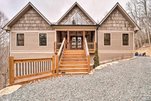 a custom log home with a front porch and stairs at Mountainside Retreat with Fire Pit in Banner Elk in Valle Crucis