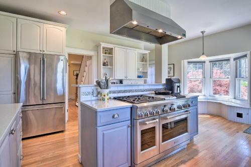 a kitchen with a stove and a refrigerator at Charming Retreat with Fire Pit and Spacious Yard! 