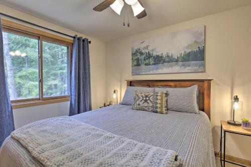a bedroom with a bed and a large window at Rhinelander Home - Jennie Webber Lake On-Site in Rhinelander