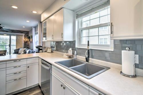 a kitchen with white cabinets and a sink at Branson Retreat with Balcony and 18-Hole Golf Course! in Branson