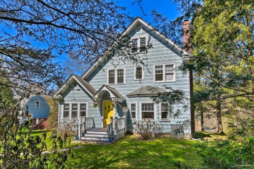 a white house with a yellow door at Charming Retreat with Fire Pit and Spacious Yard! 