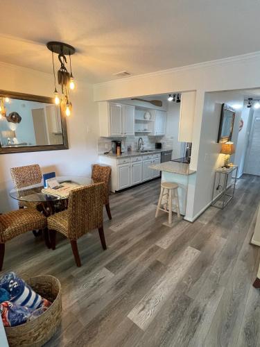 a living room with a dining table and a kitchen at St Augustine Beach Condo 3/5 Min Walk Beach/Cafes in St. Augustine