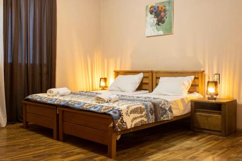 a bedroom with a bed with two towels on it at Nino's Guest House in Tbilisi City