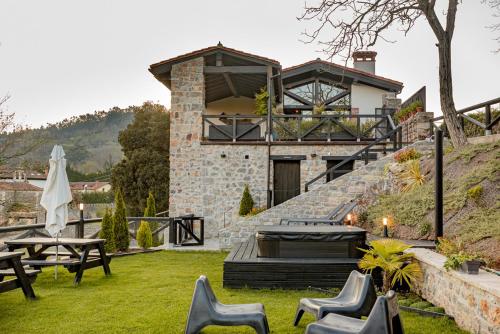 a house on the side of a hill with a patio at Apartamentos Picabel in Cangas de Onís