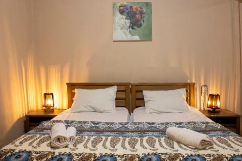 a bedroom with two beds with towels on them at Nino's Guest House in Tbilisi City