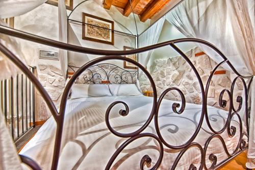 a bedroom with a metal bed in a room at Il Raduno in Castel Gandolfo