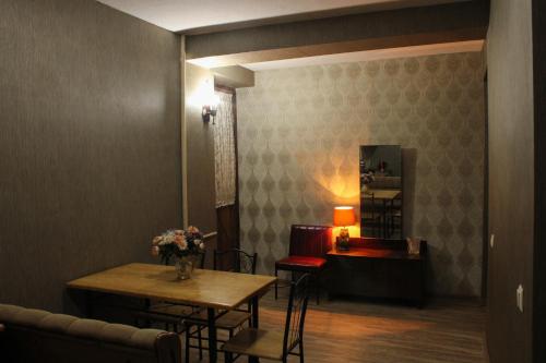 a room with a table and chairs and a mirror at Nino's Guest House in Tbilisi City