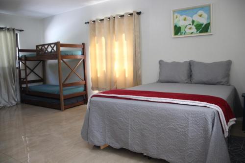 a bedroom with a bed and a chair at Hotel Fazenda Lago São Francisco in São João