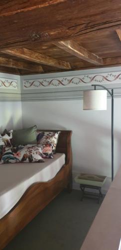 a bedroom with a bed with a wooden ceiling at La Casa sul Colle in Spoleto