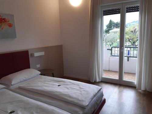 Postel nebo postele na pokoji v ubytování Hotel Villa Claudia