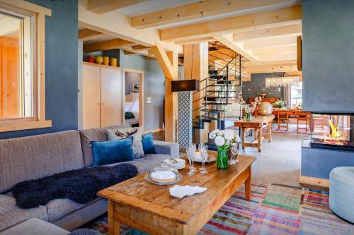 a living room with a couch and a table at Chalet Ibusta - OVO Network in Le Grand-Bornand
