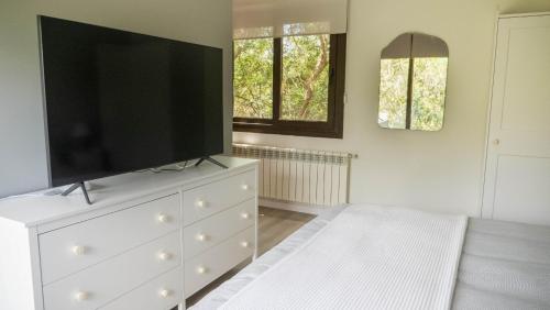 a white dresser with a television on top of it at Villa Casa Del Talaiot Sencelles in Sencelles