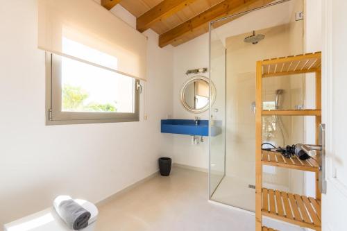a bathroom with a glass shower and a sink at Son Perot in Maria de la Salut