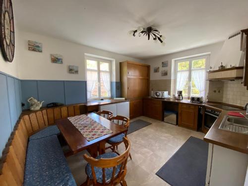 a kitchen with a table and chairs in a room at Haus Silberdistel in Todtmoos