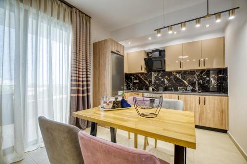 a kitchen and dining room with a wooden table and chairs at Sapphire Horizon Suites in Kissamos