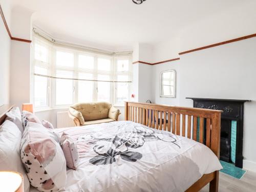 1 dormitorio con 1 cama y 1 silla en Ninety Eight en Southend-on-Sea